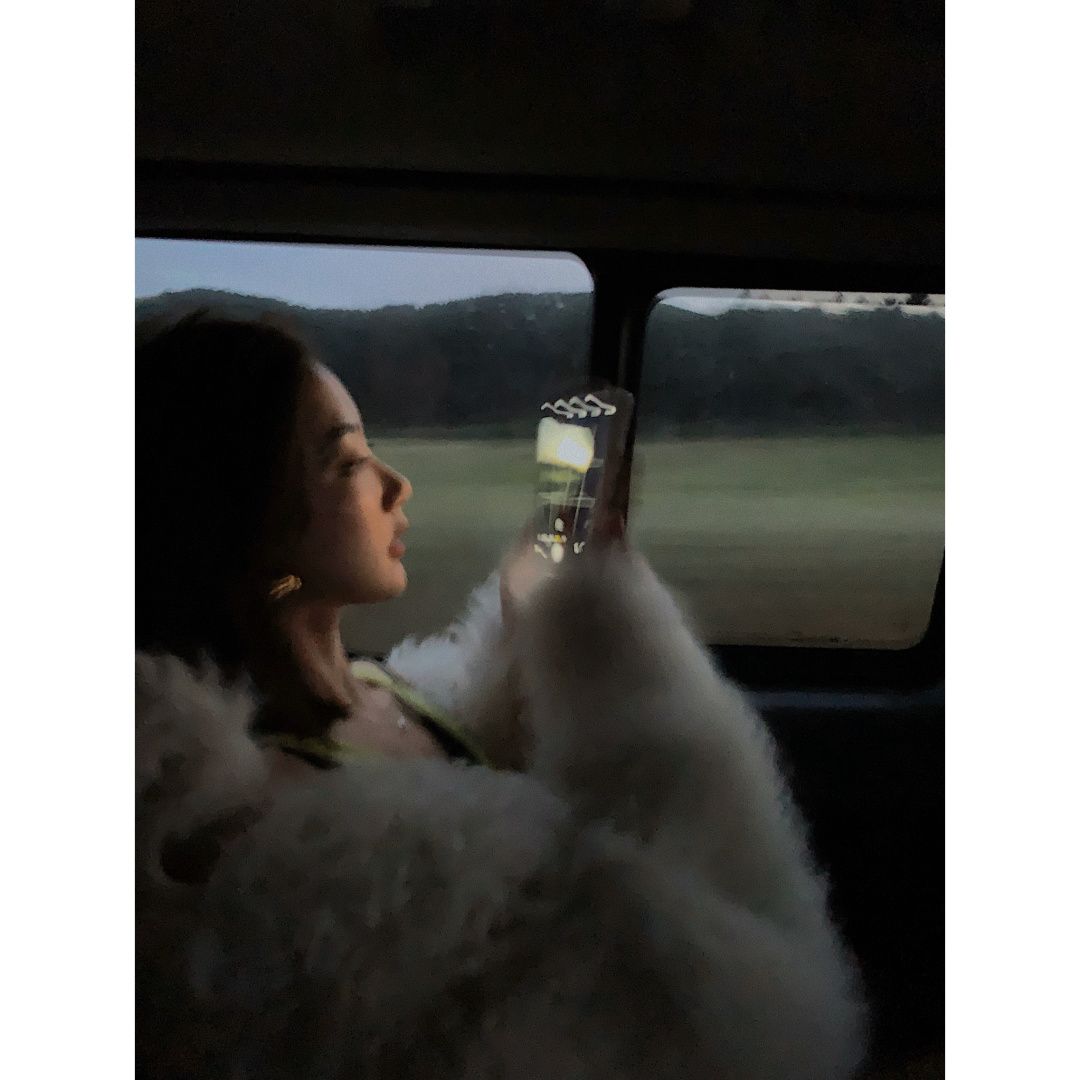 girl taking photo in car
