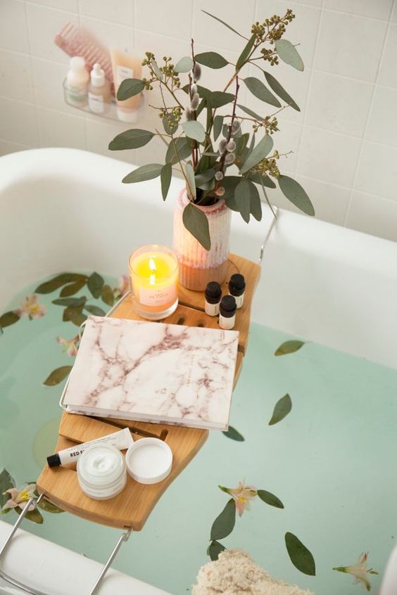 candle on bath tray in bathroom