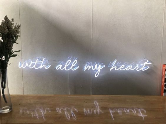 White neon light saying "with all my heart"