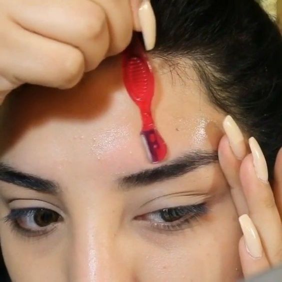 Girl shaving eyebrows