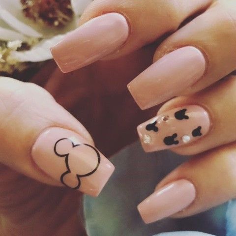 Light pink nails with black mickey mouse designs
