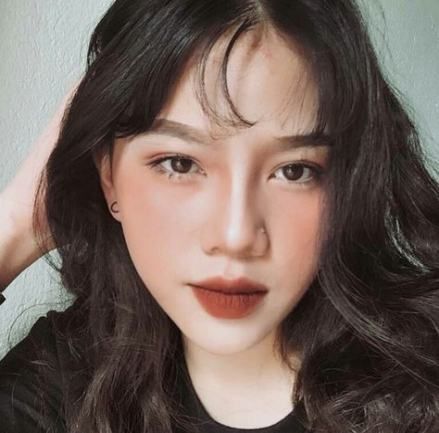 Asian woman wearing dark lipstick