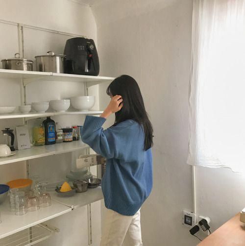 Girl looking at her utensils in the kitchen