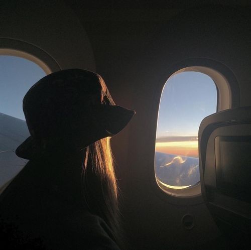 Girl looking out the airplane window