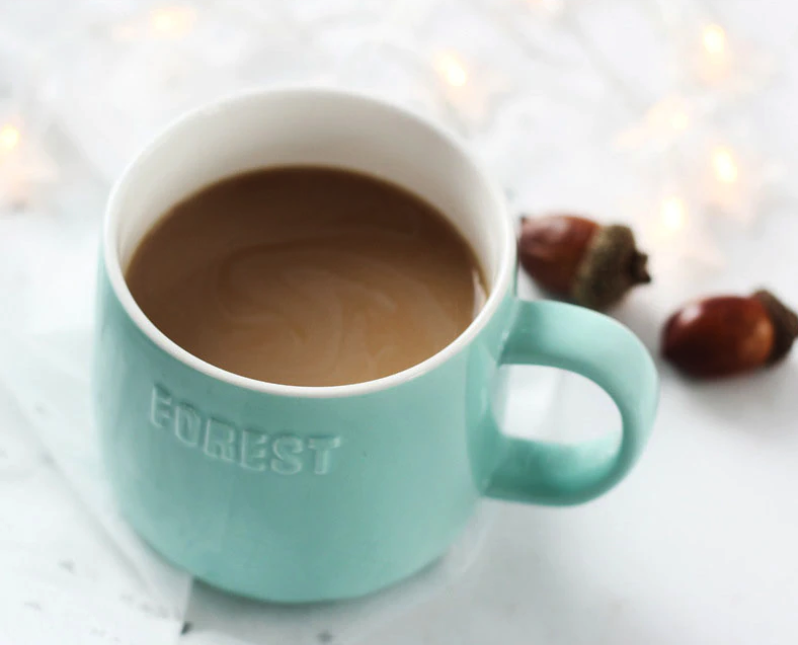ceramic mug comes with a glass dome lid that has woodland creatures in a forest