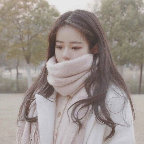 Girl looking down in winter clothes