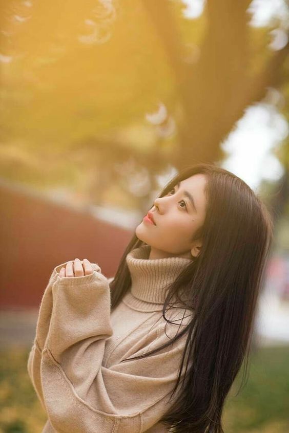 Girl in the park with autumn leaves