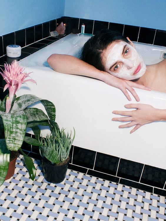woman having a facial in the bathtub