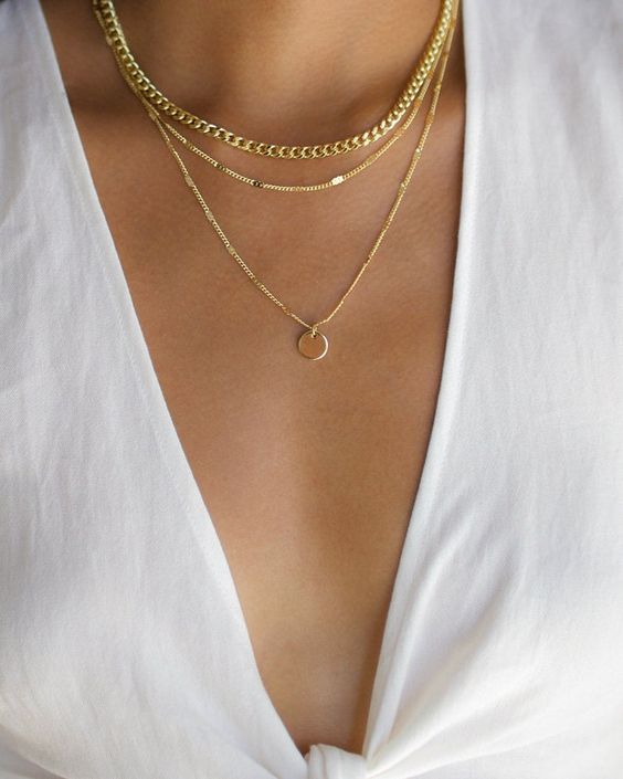 Layered necklaces with low v-neck top