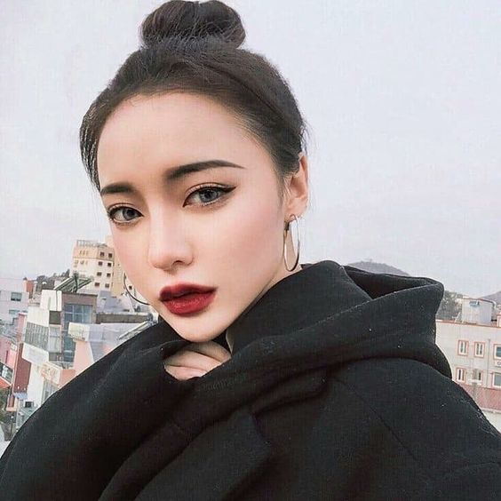asian woman with a soft goth makeup look