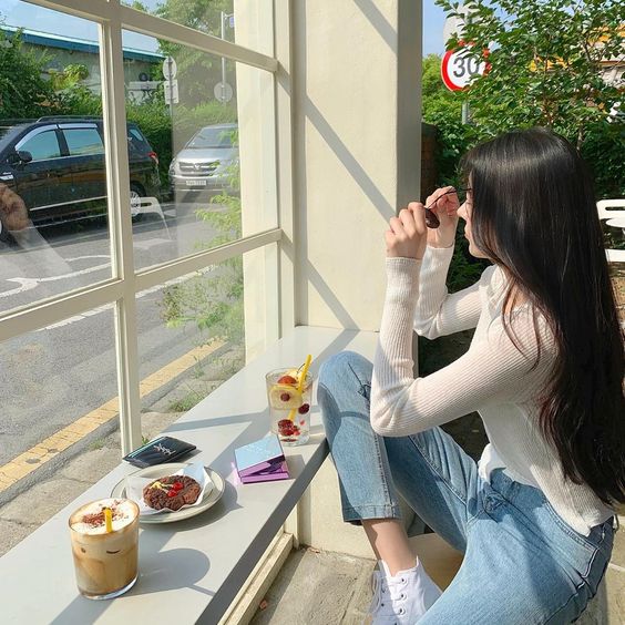Girl staring out cafe window