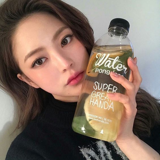 Girl posing with bottle of water