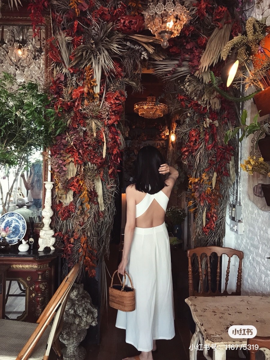 Girl walking into floral cafe