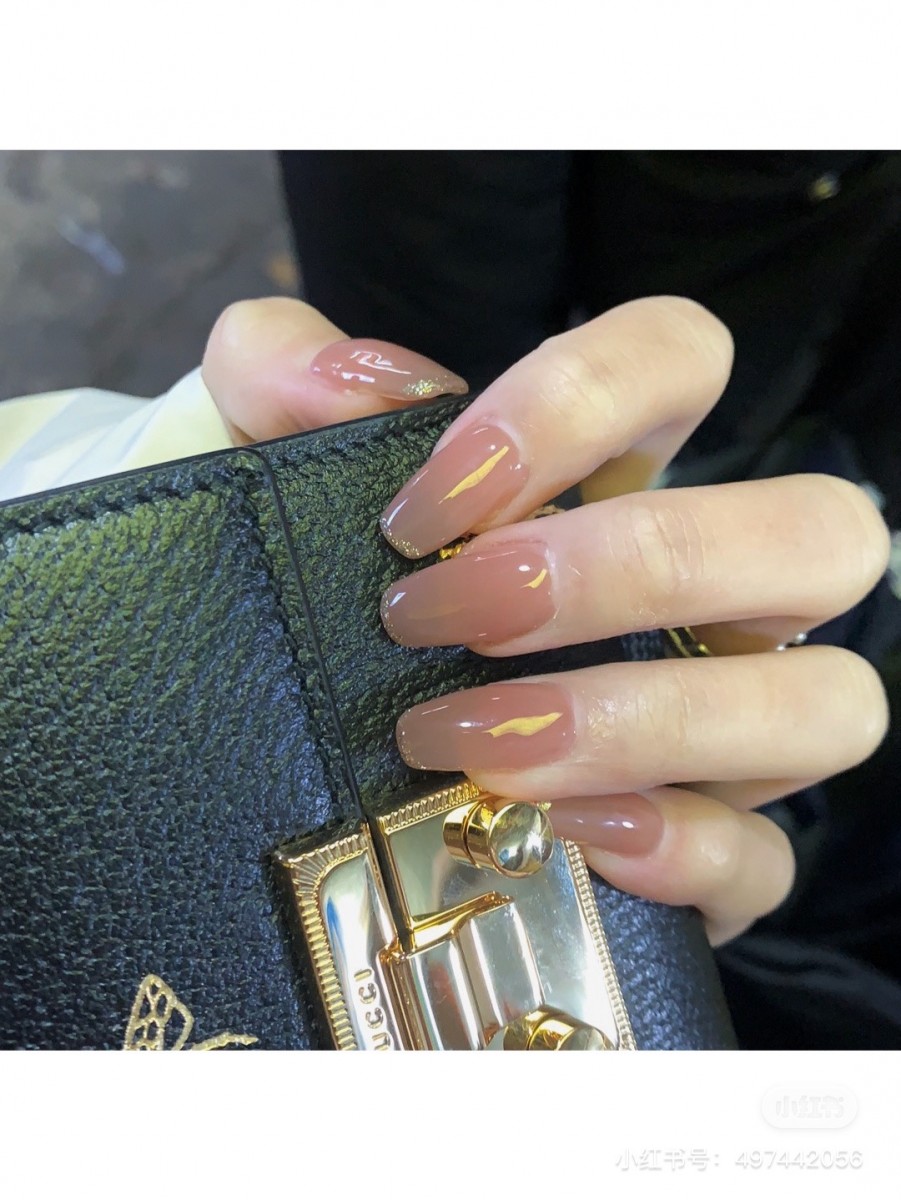 Showing manicure while holding wallet