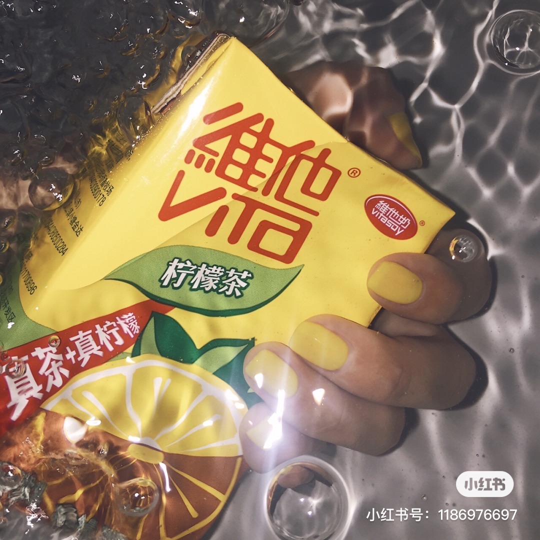 Yellow nails holding a yellow drink