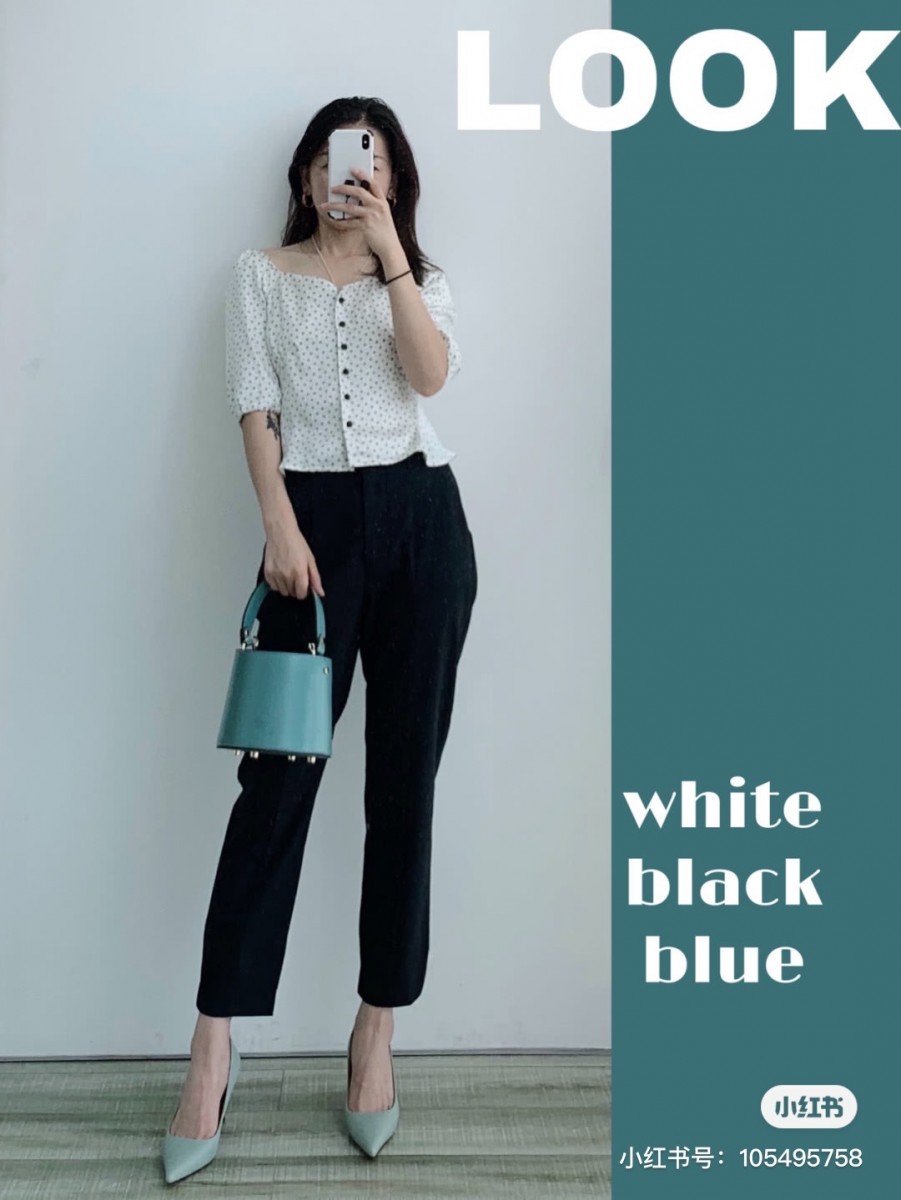 White top, black pants, blue bag
