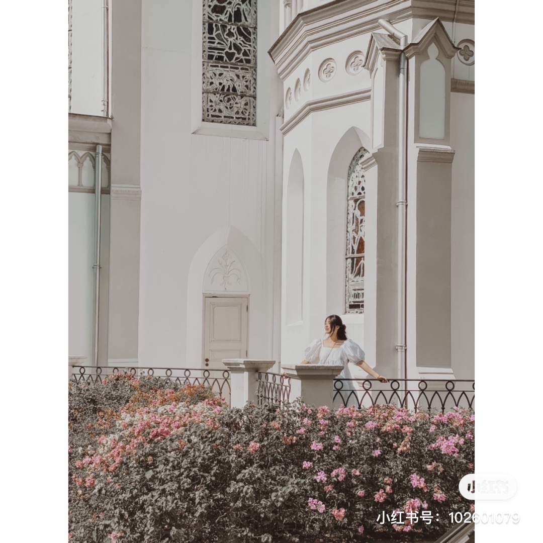 Posing outside CHIJMES, wearing white
