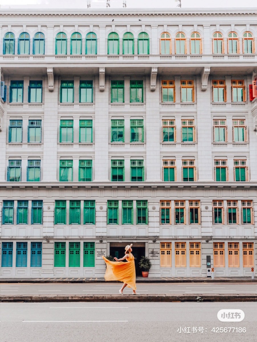 Girl posing in front of MCI and fluttering her dress