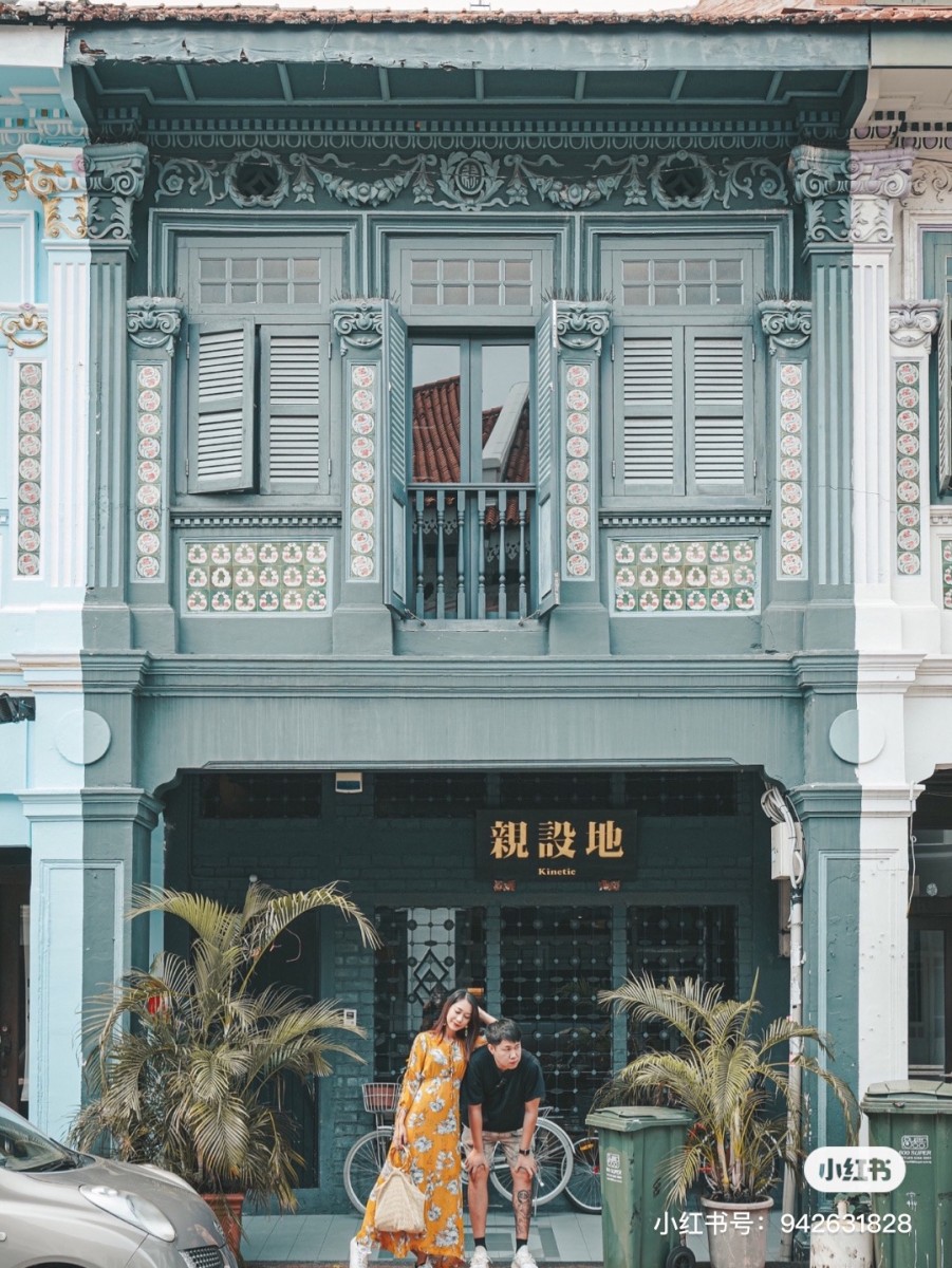 Couple posing in front of shophouse