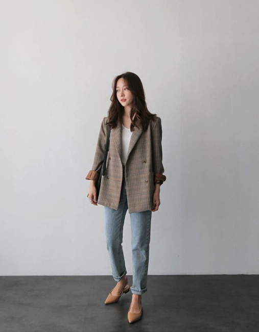 asian woman wearing a brown blazer