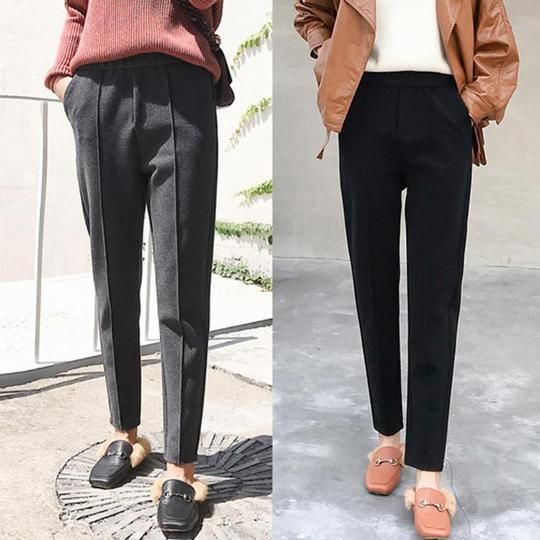 two women wearing black trousers