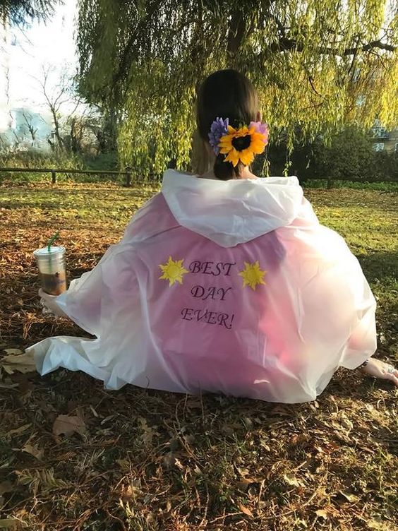 girl wearing poncho with sunflowers