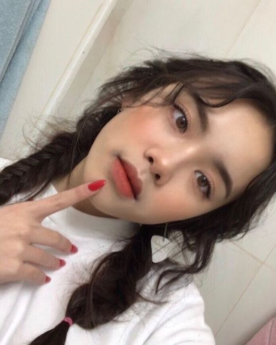 Girl applied blusher on cheeks and nose