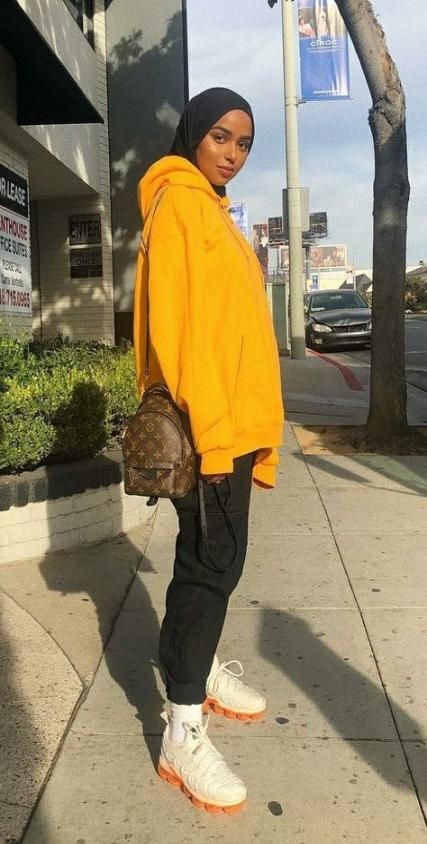 woman wearing a yellow hoodie and hijab