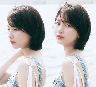 Suzy with short hair posing near the sea
