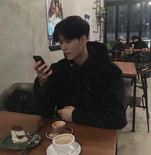 Guy using phone in a cafe