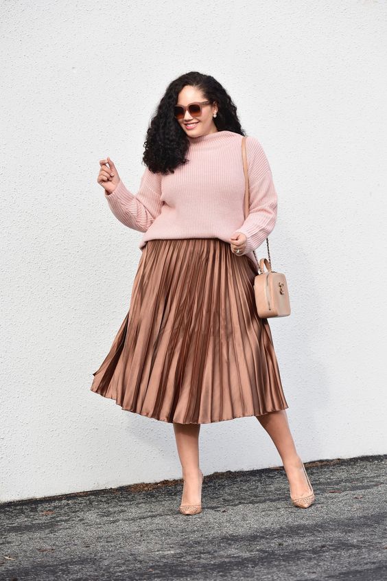 woman wearing sweater and pleated skirt