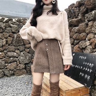 woman wearing sweater and mini skirt