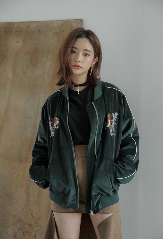 Asian woman wearing a bomber jacket