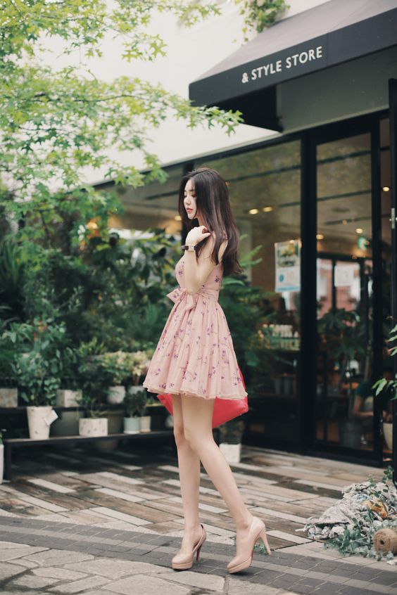 asian woman walking in heels in a pink dress