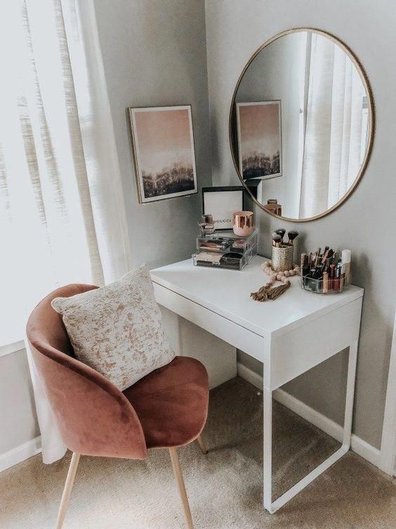 vanity with round mirror and pink velvet chair