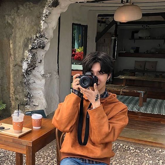 Guy taking photo using camera