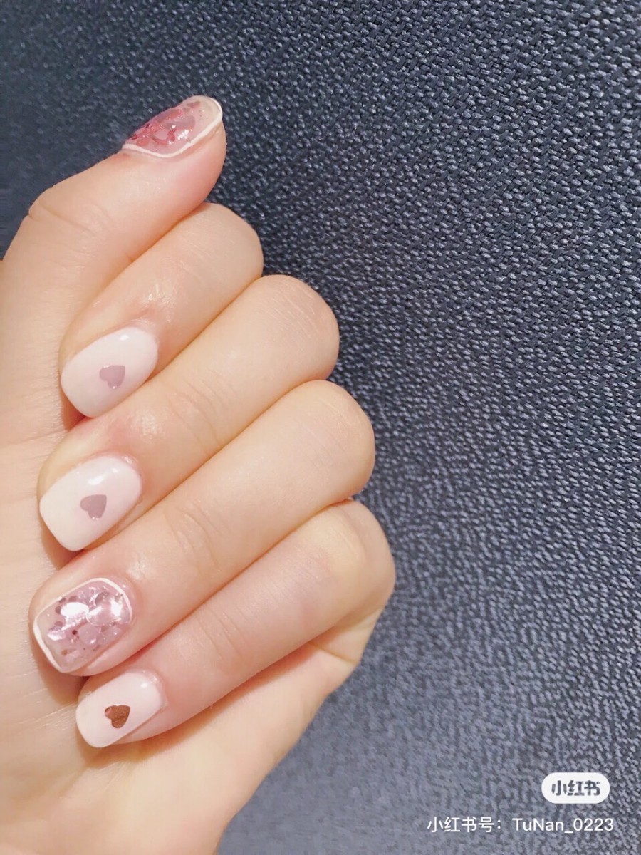 Light pink and shiny heart nails