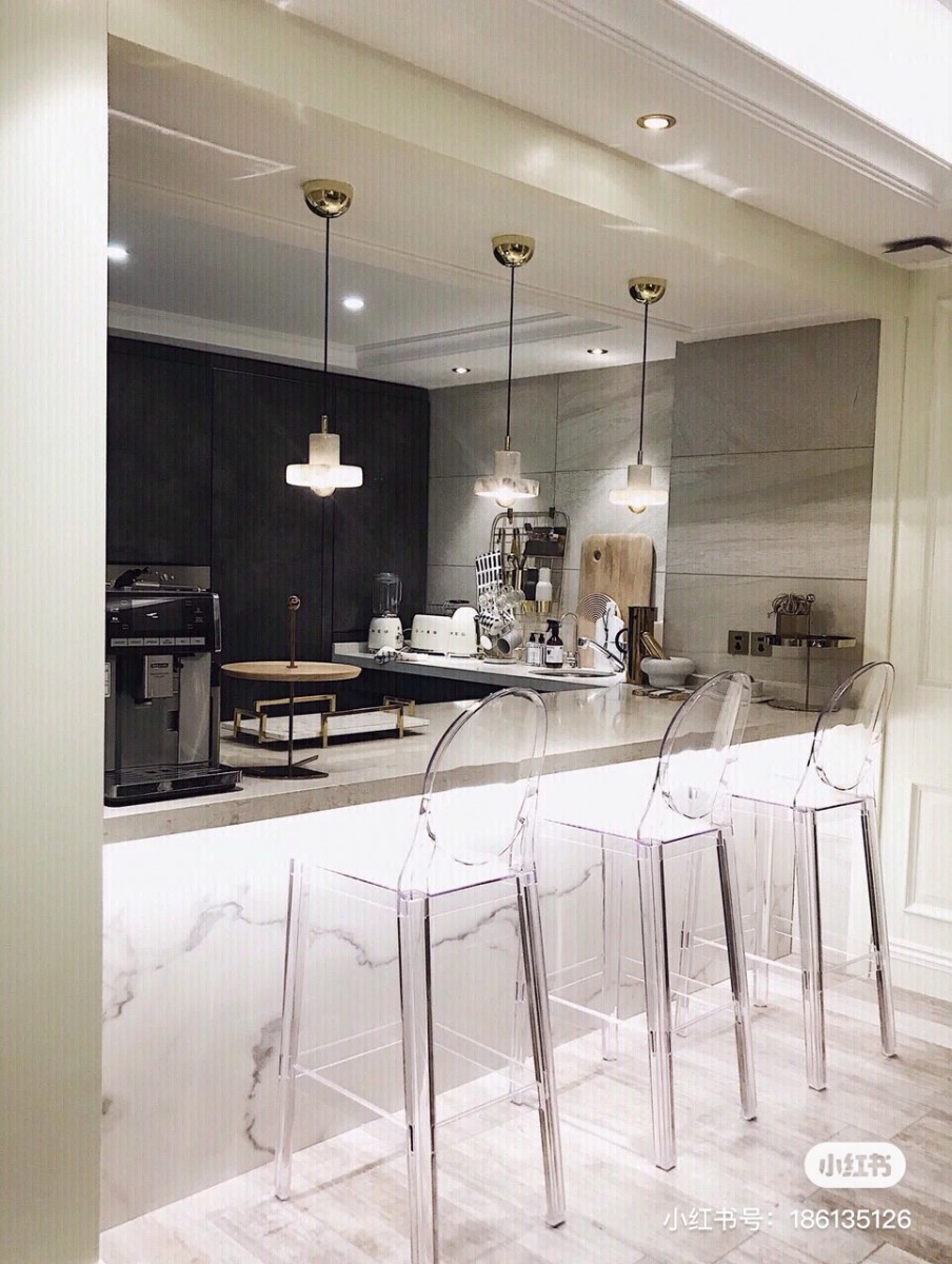 Bar counter in kitchen with transparent high chairs