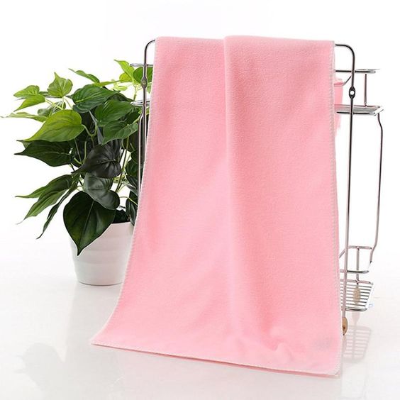a pink microfibre towel to reduce frizz in hair