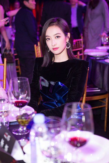 Victoria with short hair posing at a dinner party