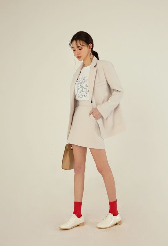 woman wearing blazer and mini skirt