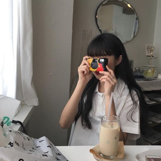 Girl using a film camera