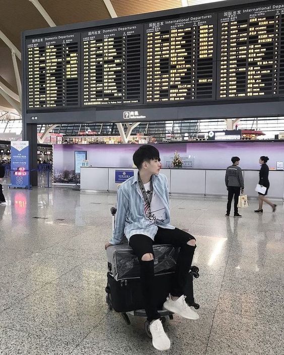asian guy with luggage airport fashion
