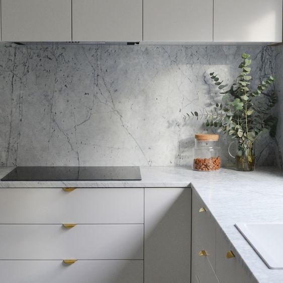 White kitchen with white marble wall tiles