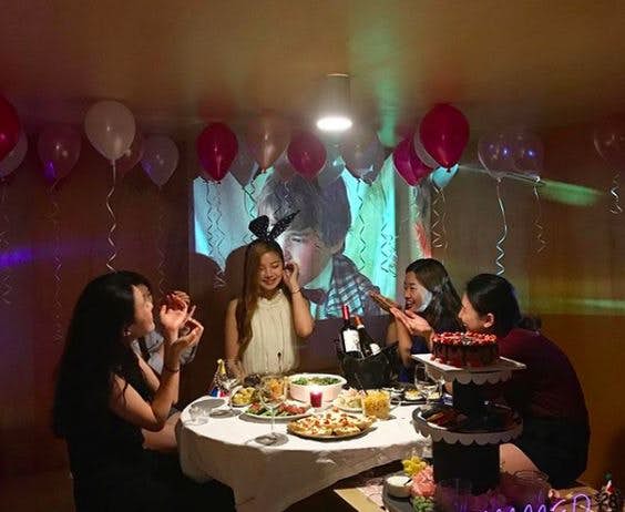 house party at home among group of Singaporean friends with balloons