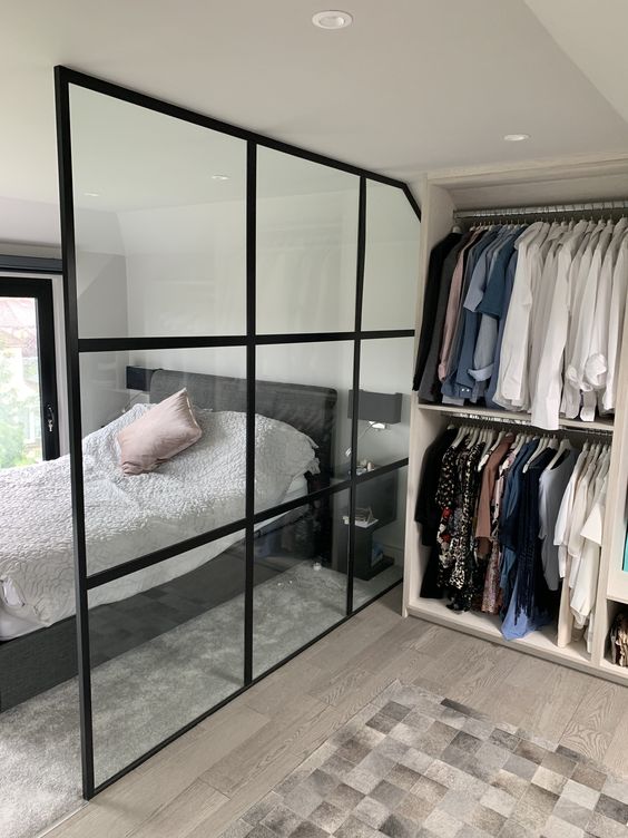 Walk-In Wardrobe In A Small HDB bto Flat with glass partition wall with black grid frames