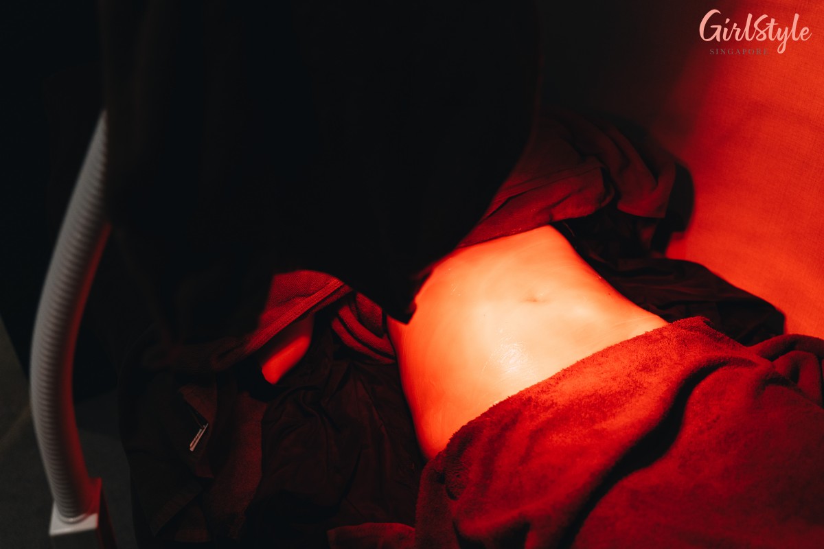 Shining infrared light on model's tummy at Bottomslim