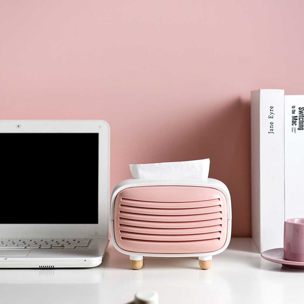 cute cheap tissue paper box cover shaped like a mini retro radio in pink on work desk beside laptop