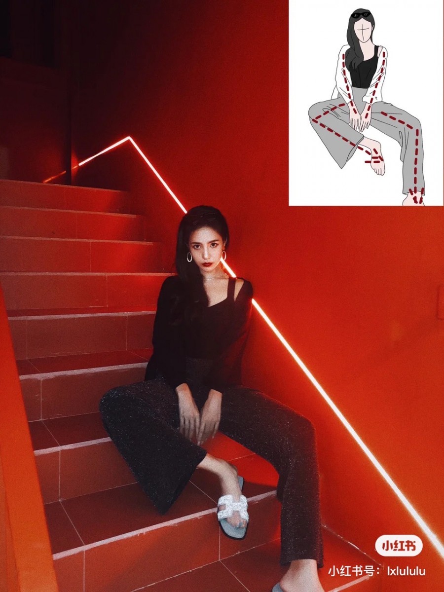 Girl sitting down on stairs with one leg folded