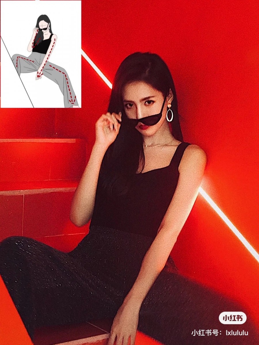 Girl sitting down on the stairs, touching her sunglasses